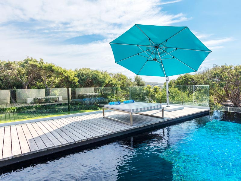 blue frankford umbrella by pool